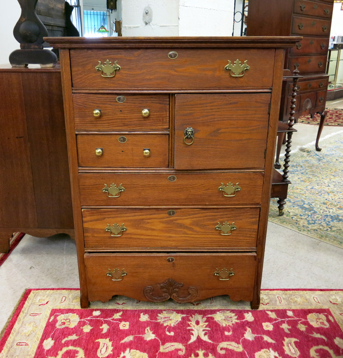 Appraisal: AN OAK CHIFFONIER American c the front featuring two small