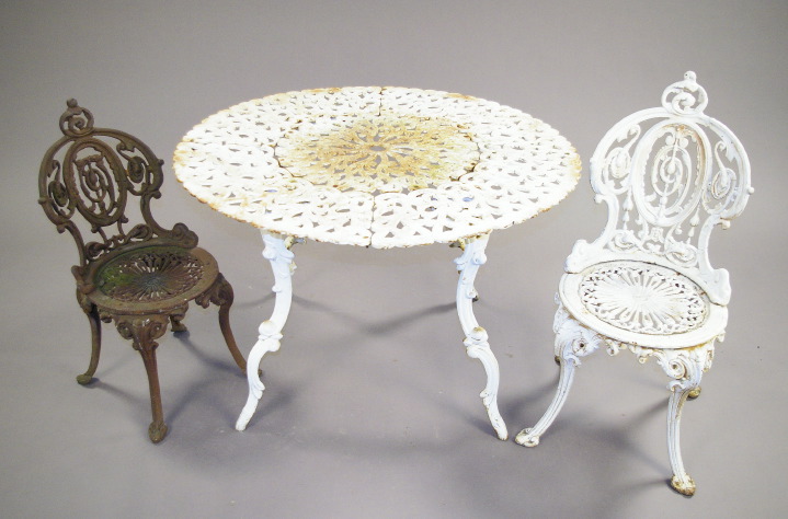 Appraisal: Late Victorian-Style Cast-Iron Circular Garden Table and Four Chairs presented