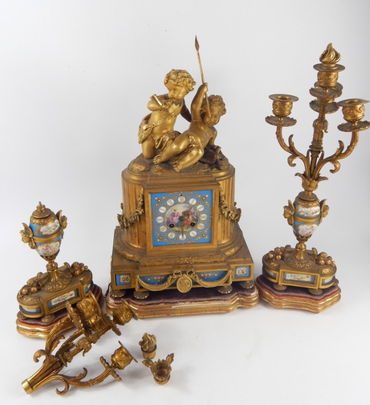 Appraisal: A French late thC ormolu and porcelain clock garniture by