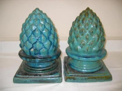 Appraisal: A PAIR OF TERRACOTTA FINIALS modelled as pineapples with an