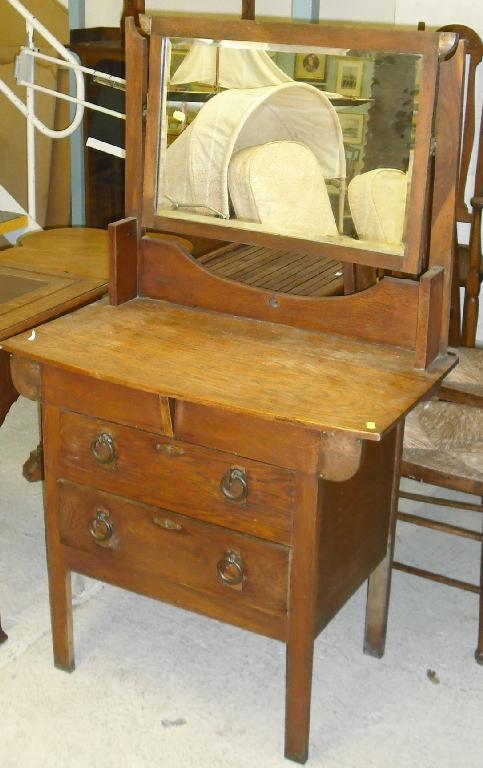 Appraisal: Oak Arts Crafts dressing chest the bevelled rectangular swing mirror