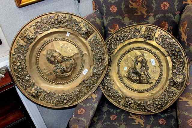 Appraisal: A PAIR OF LARGE BRASS WALL PLAQUES with embossed decoration