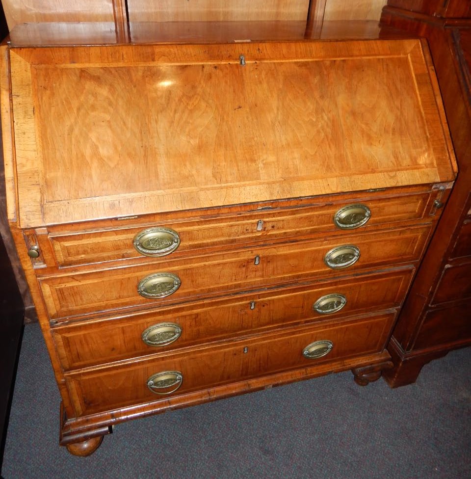 Appraisal: An thC walnut and feather banded bureau the crossbanded fall