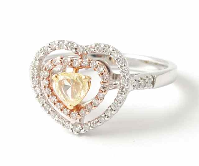 Appraisal: DIAMOND YELLOW DIAMOND AND FOURTEEN KARAT WHITE GOLD HEART RING