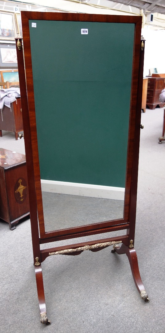 Appraisal: A th century gilt metal mounted mahogany cheval mirror with