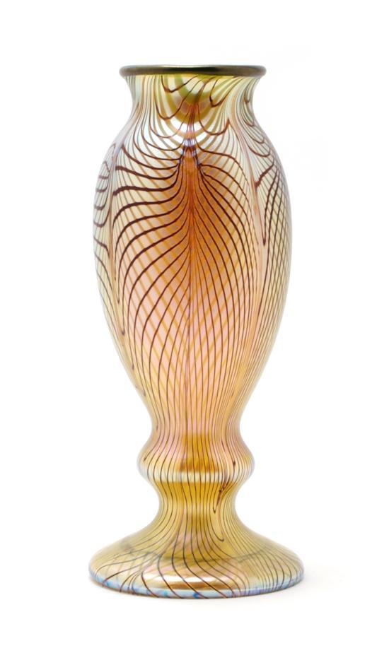 Appraisal: An Iridescent Glass Vase of baluster form having pulled linear