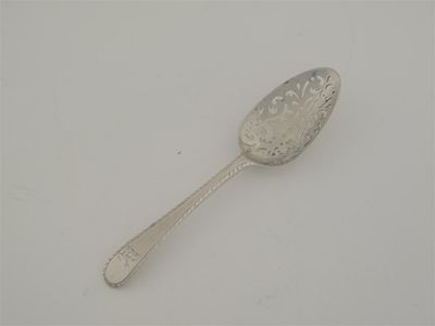 Appraisal: A rare George III feather-edge strainer spoon crested the bowl