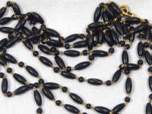 Appraisal: An carat gold and ebony bead long guard chain circa