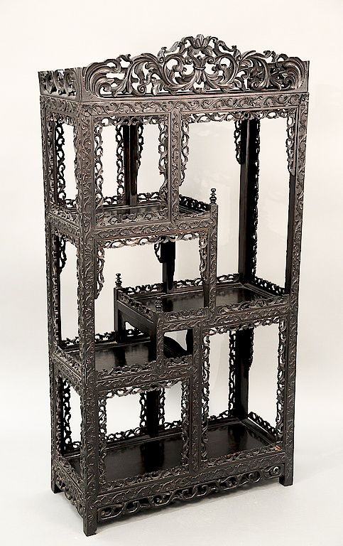 Appraisal: Chinese hardwood etagere with pierced carved trim th century Being