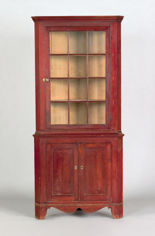 Appraisal: Pennsylvania cherry two part corner cupboard th c retaining an