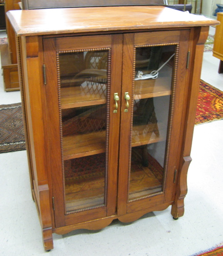 Appraisal: PINE EMPIRE REVIVAL CABINET American c the front featuring a