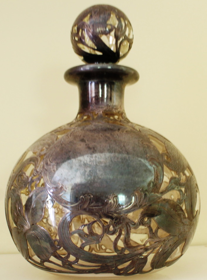 Appraisal: A silver encased glass eau de cologne bottle and stopper