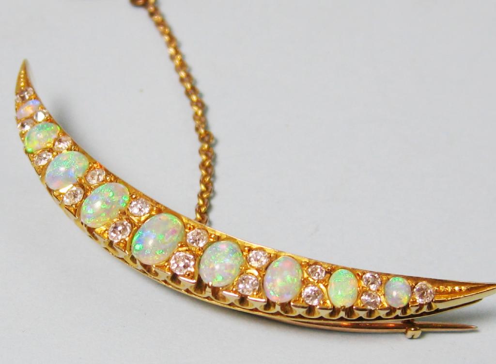 Appraisal: An Opal and Diamond Crescent Brooch pave-set nine graduated opals