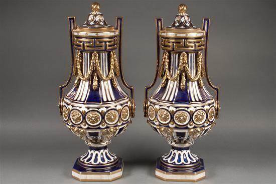 Appraisal: Pair of Continental style cobalt parcel-gilt decorated porcelain two-handled urns