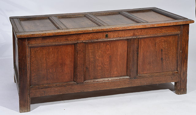 Appraisal: AN ANTIQUE OAK COFFER of pegged construction with quadruple panelled