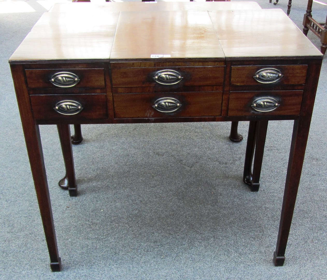 Appraisal: A George III mahogany dressing table with central lift top