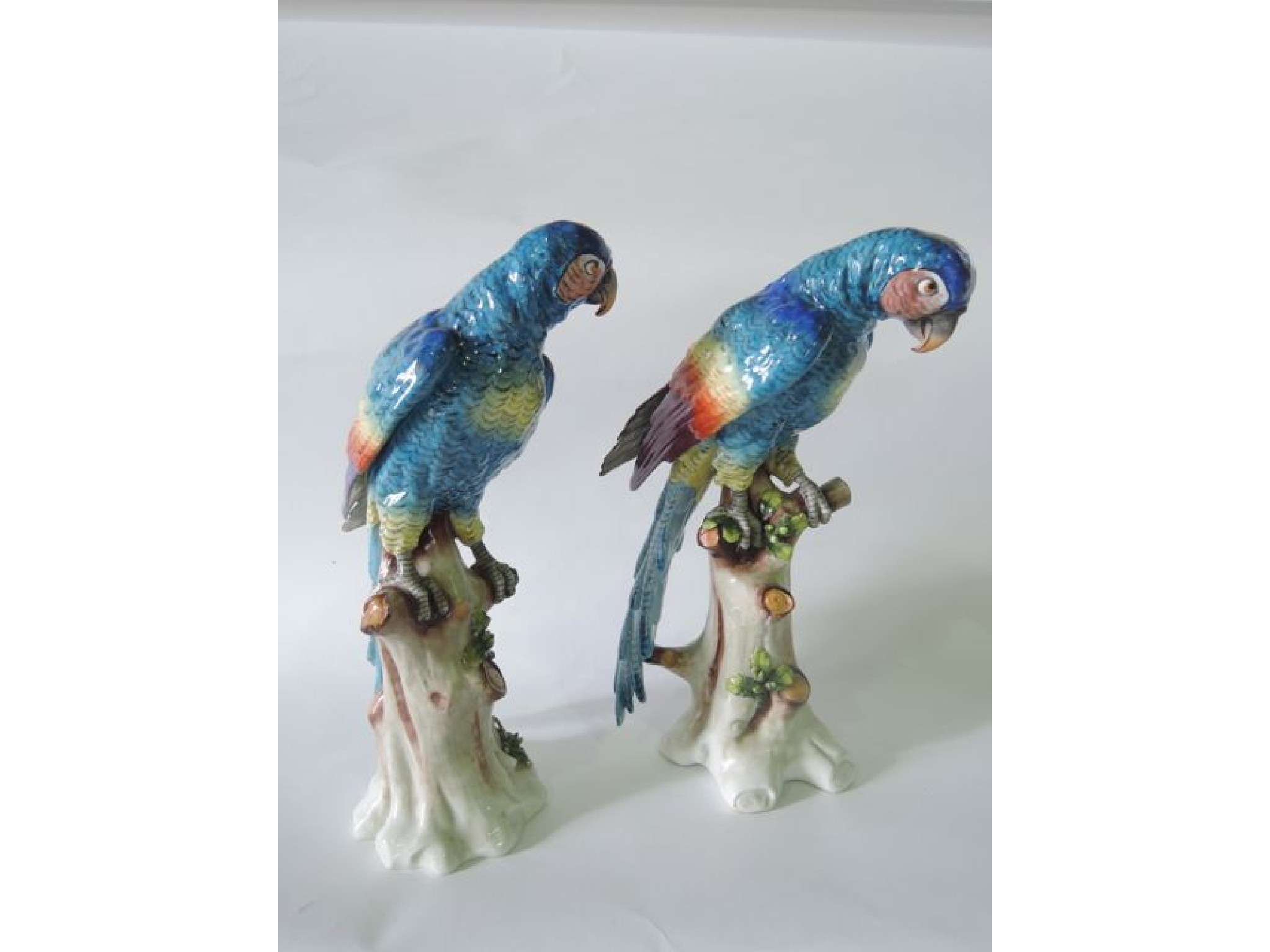 Appraisal: A pair of large continental models of parrots with turquoise