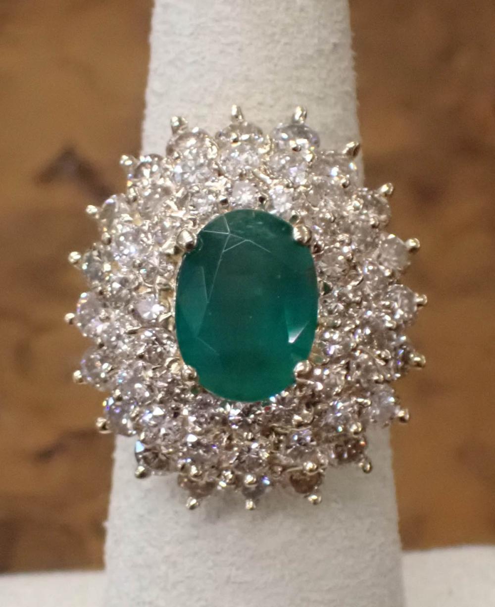 Appraisal: DIAMOND EMERALD AND FOURTEEN KARAT GOLD RING The yellow gold