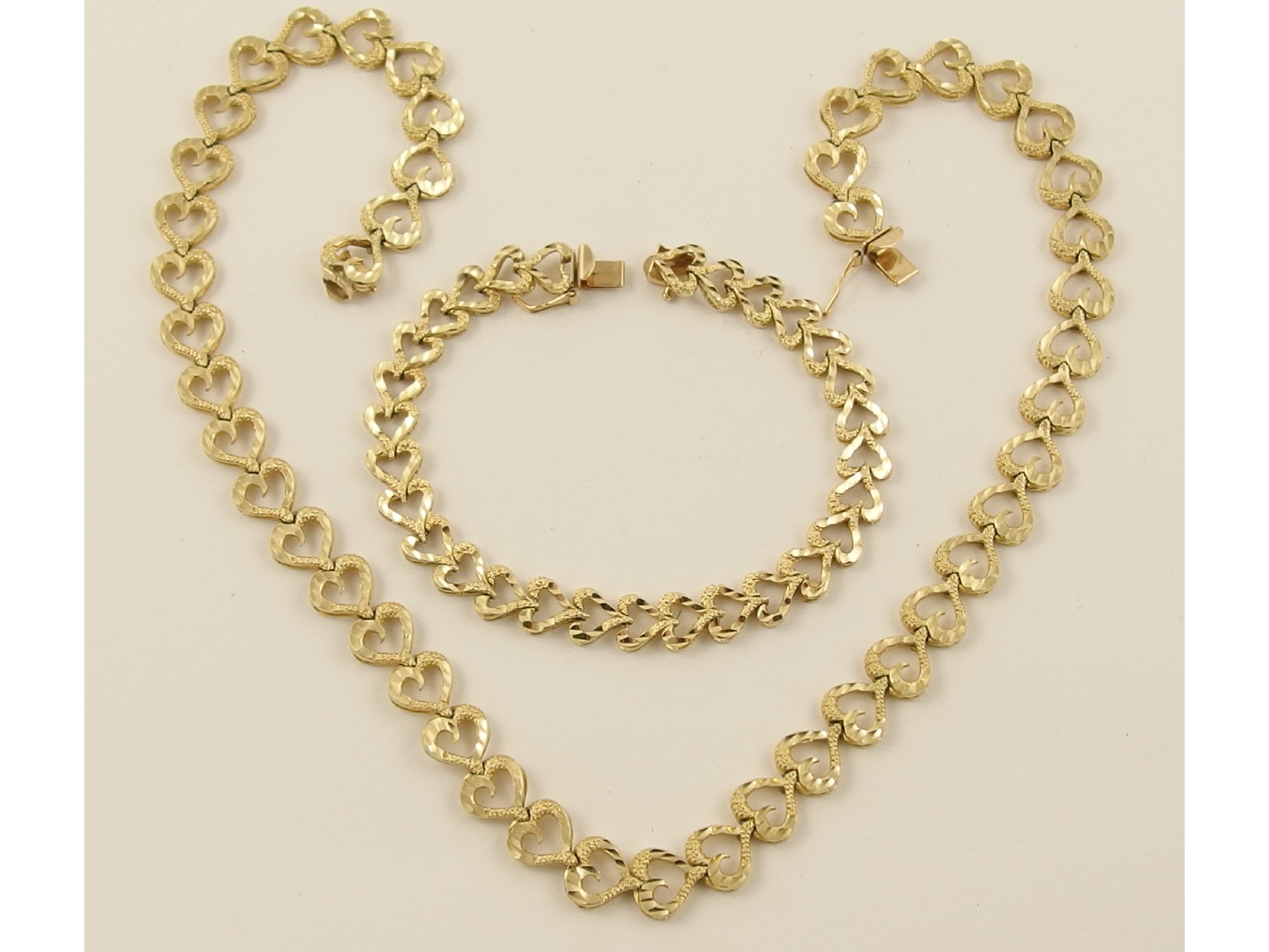 Appraisal: A ct necklet and bracelet set with heart shaped links