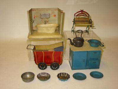 Appraisal: A Wells tinplate miniature dolls pram long a DBW toys