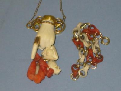 Appraisal: A VICTORIAN CORAL HAND PENDANT modelled as a white composition