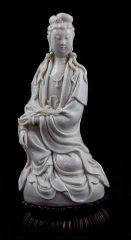 Appraisal: CHINESE BLANC-DE-CHINE FIGURE OF GUANYIN late Qing dynasty with double