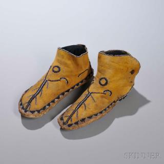 Appraisal: Apache Beaded Hide Man's Moccasins c s with thick rawhide