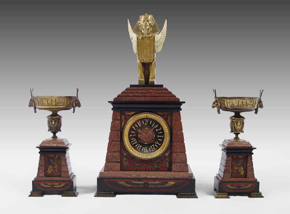 Appraisal: S HYMAN EGYPTIAN REVIVAL MARBLE CLOCK GARNITURE Carved marble and