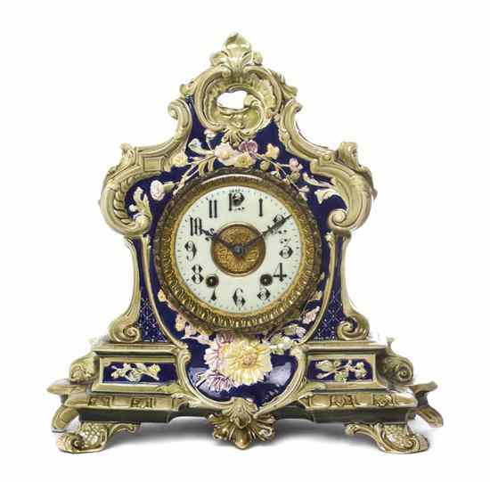 Appraisal: A German Ceramic Mantel Clock the cartouche form floral decorated