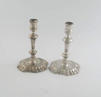 Appraisal: A pair of George II cast candlesticks on shaped and