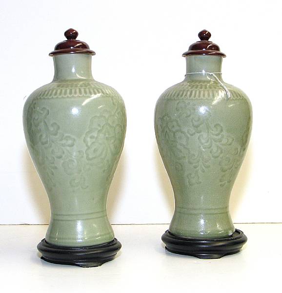 Appraisal: A pair of celadon glazed porcelain vases With carved underglaze