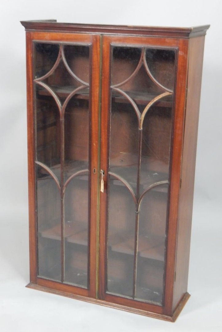 Appraisal: A thC mahogany bookcase with two astragal glazed doors and