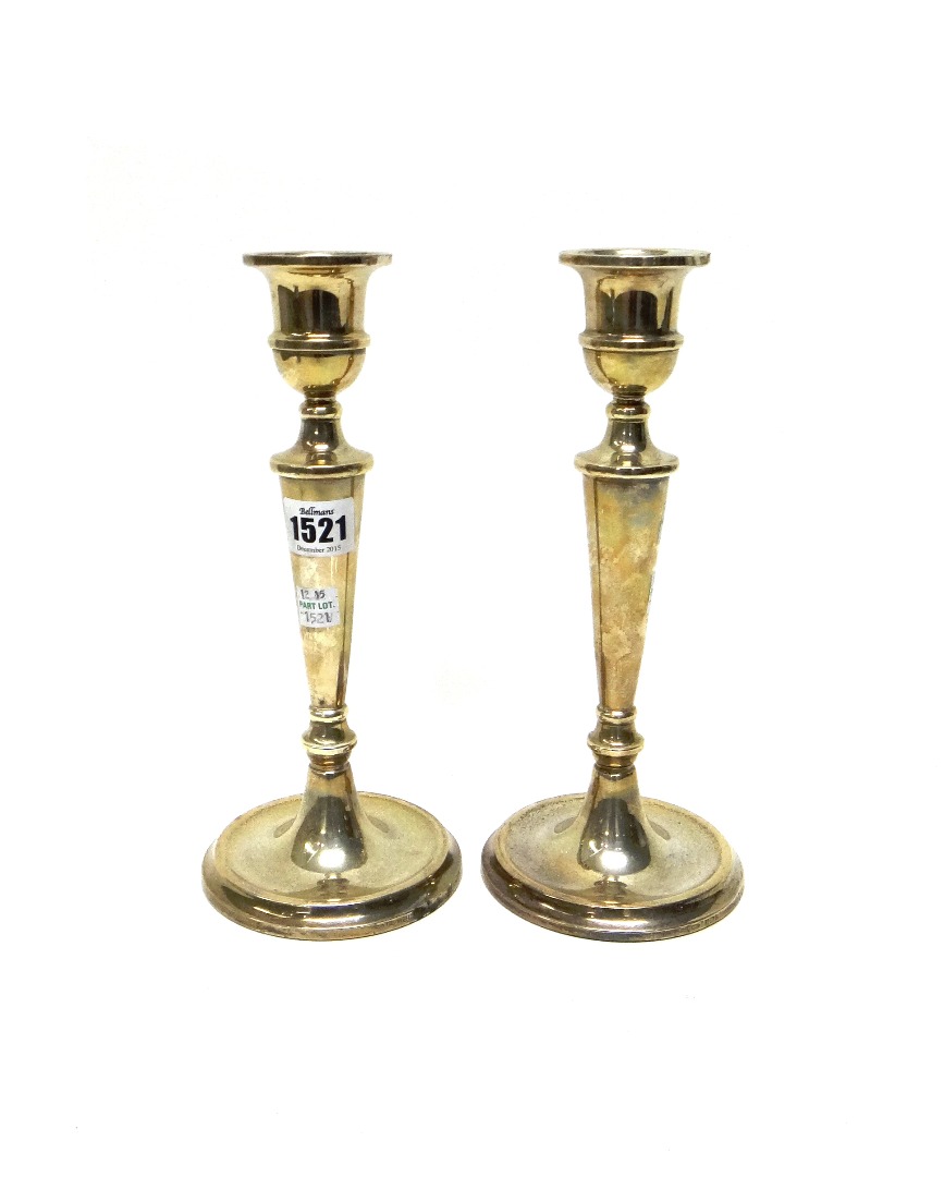 Appraisal: A pair of silver table candlesticks each having a tapered