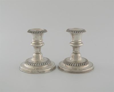 Appraisal: A pair of dwarf candlesticks with round bases and gadrooning