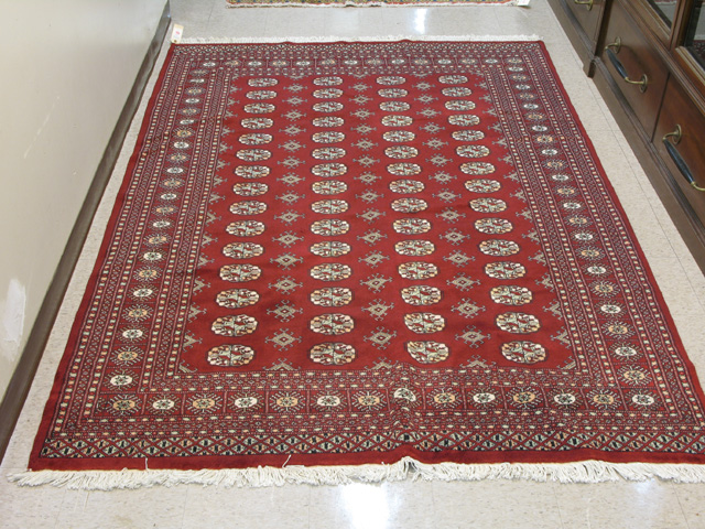 Appraisal: PAKISTANI BOKHARA CARPET overall Turkoman gol design on bright red