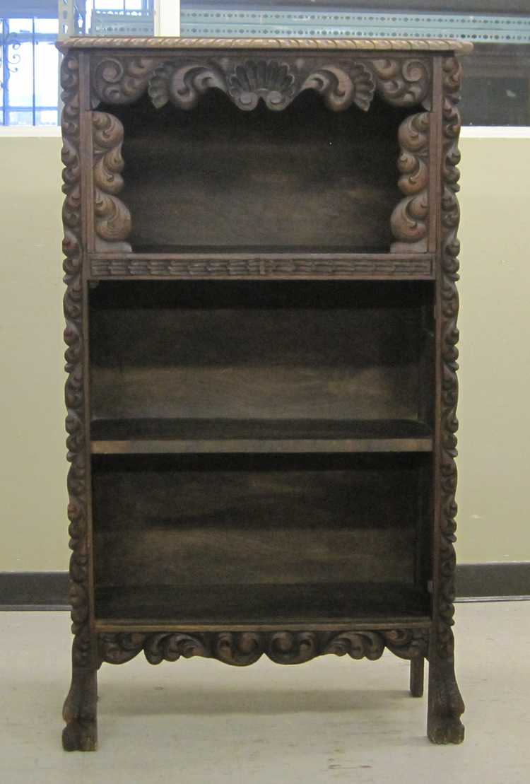 Appraisal: CARVED OPEN SHELF BOOKCASE early th century having three open