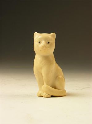 Appraisal: A carved ivory model of a seated cat with painted