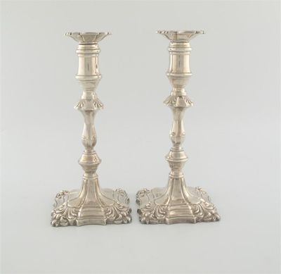 Appraisal: A pair of modern candlesticks on shaped square bases with