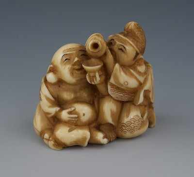 Appraisal: A Carved Ivory Netsuke of a Two Men A fat