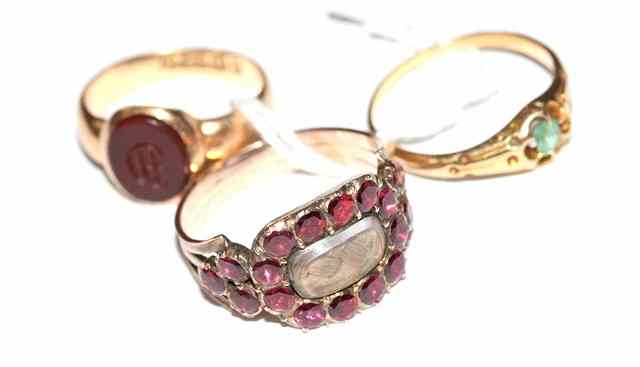 Appraisal: A VICTORIAN GARNET SET MOURNING RING oval inset plaited hair