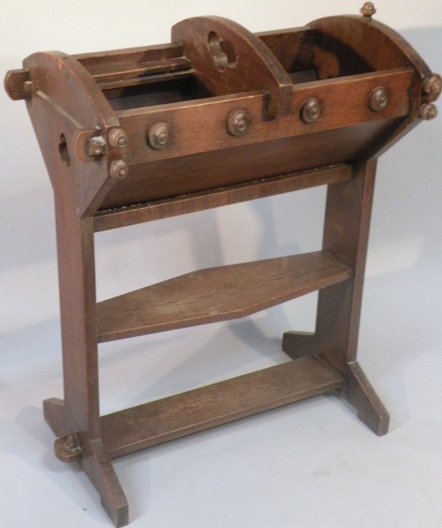 Appraisal: An Edwardian oak gothic book trough with a shaped section