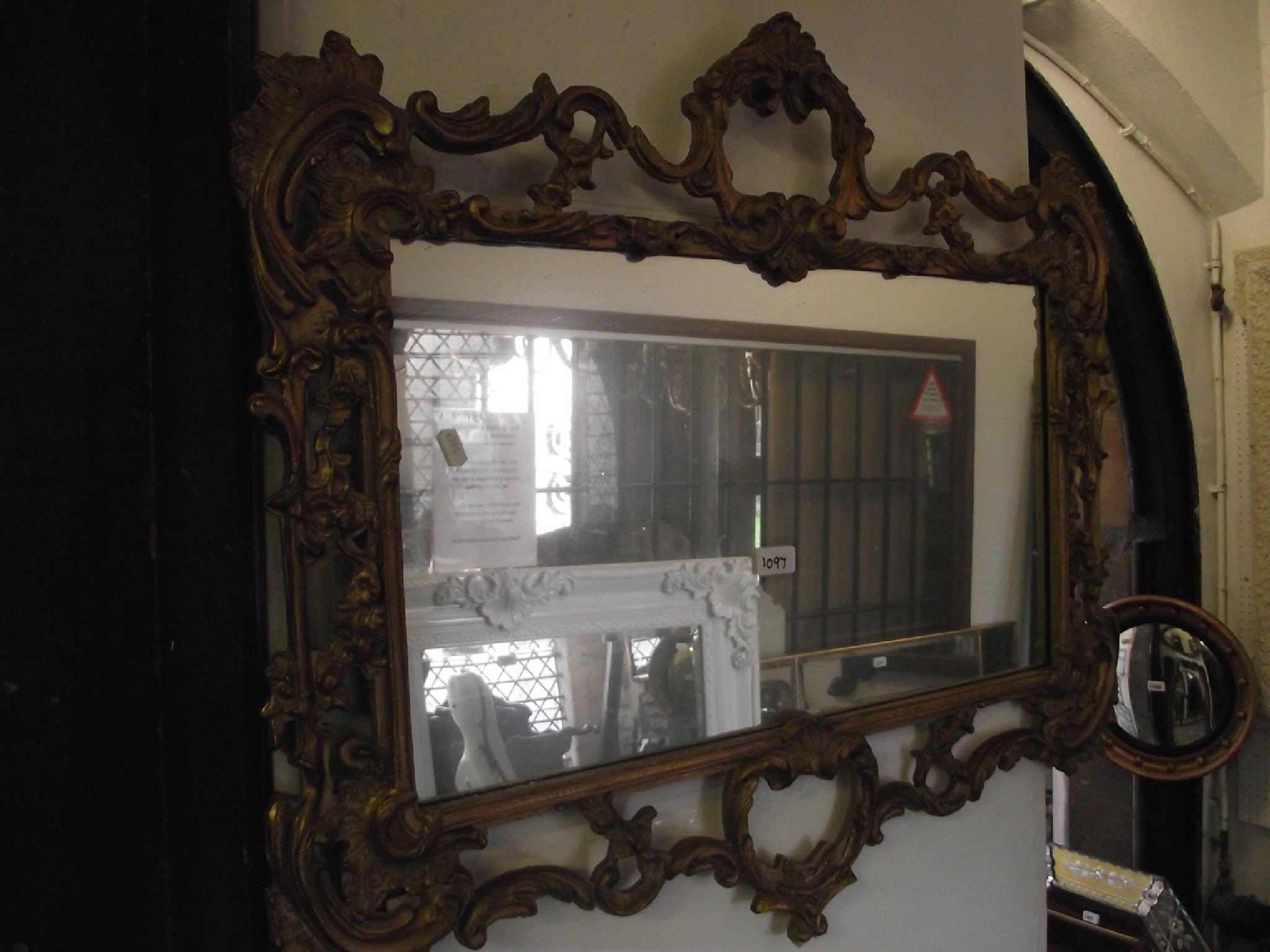 Appraisal: An antique style gilt framed wall mirror the scrolling acanthus