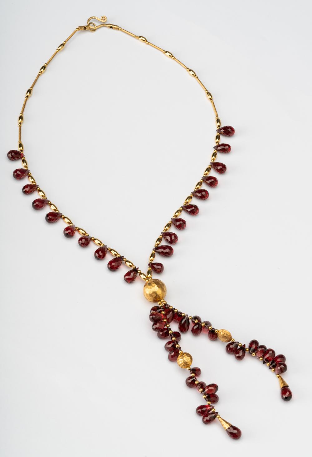 Appraisal: KARAT YELLOW GOLD GARNET NECKLACEStrung with pear shape briolette cut