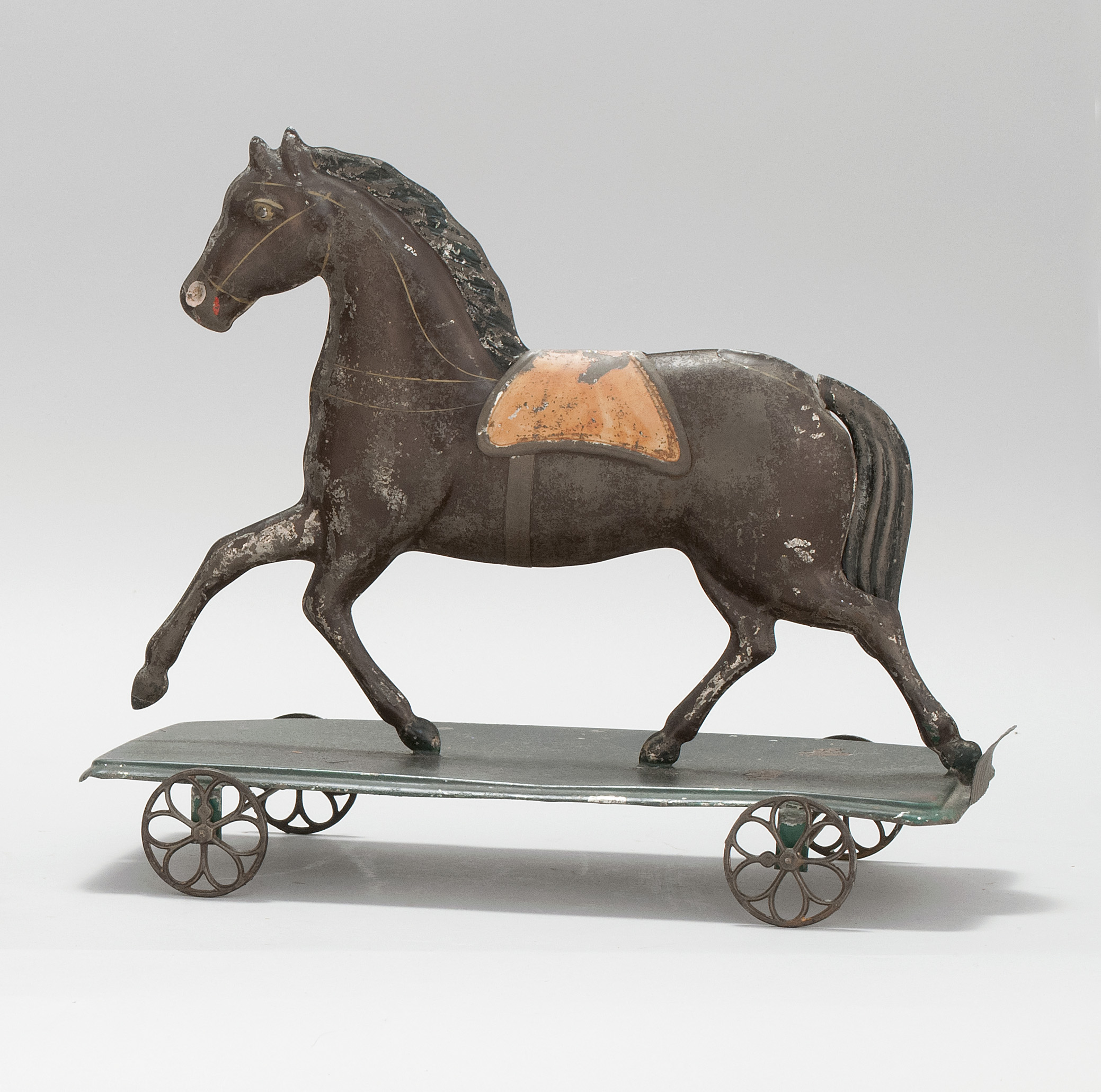 Appraisal: PRESSED TIN HORSE ON PLATFORM PULL TOY Circa In original