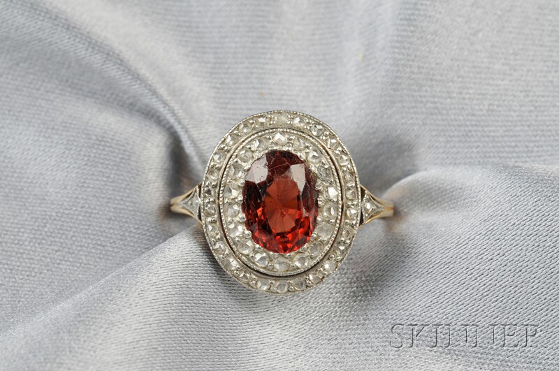 Appraisal: Garnet and Diamond Ring the cushion-cut garnet framed by a