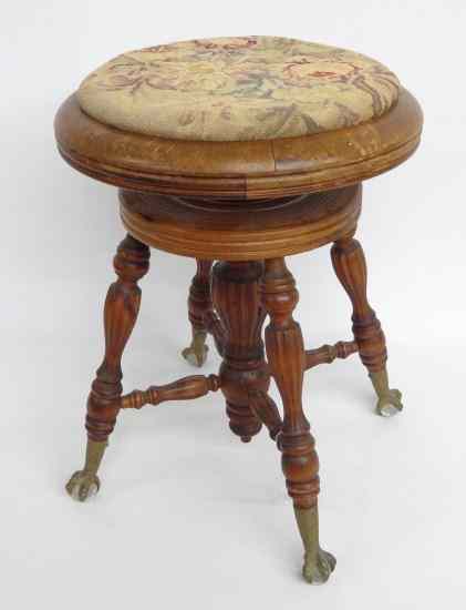 Appraisal: C 's piano stool with brass tenons and glass ball