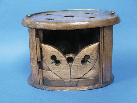 Appraisal: A WOODEN CARRIAGE FOOT WARMER of oval form with pierced