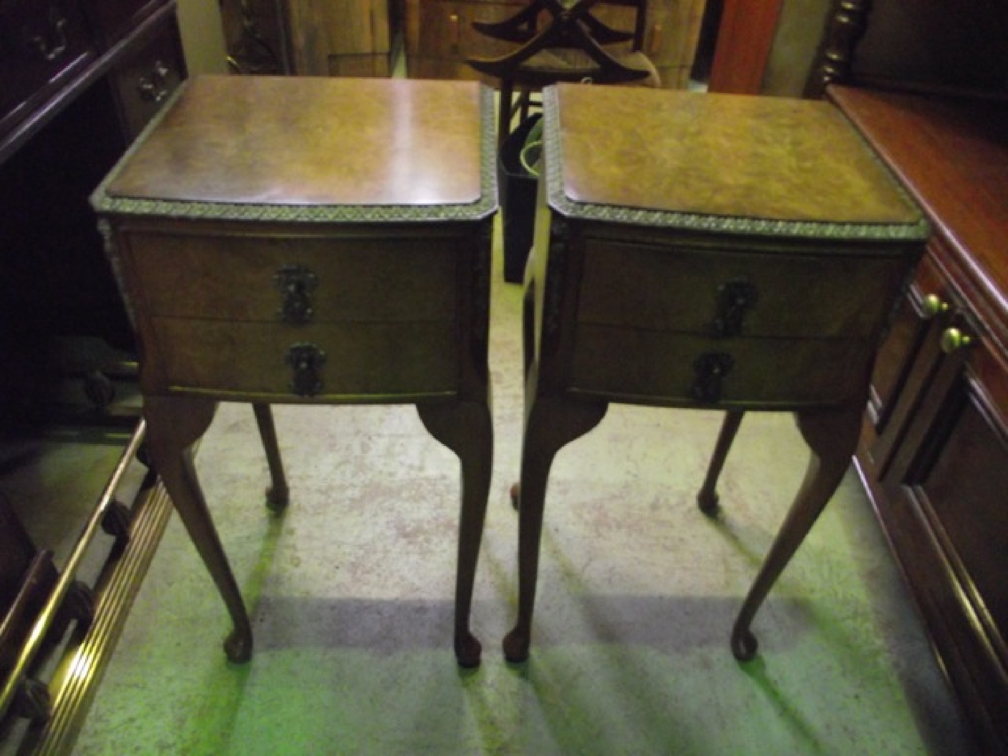 Appraisal: A pair of walnut veneered and slightly bow fronted bedside