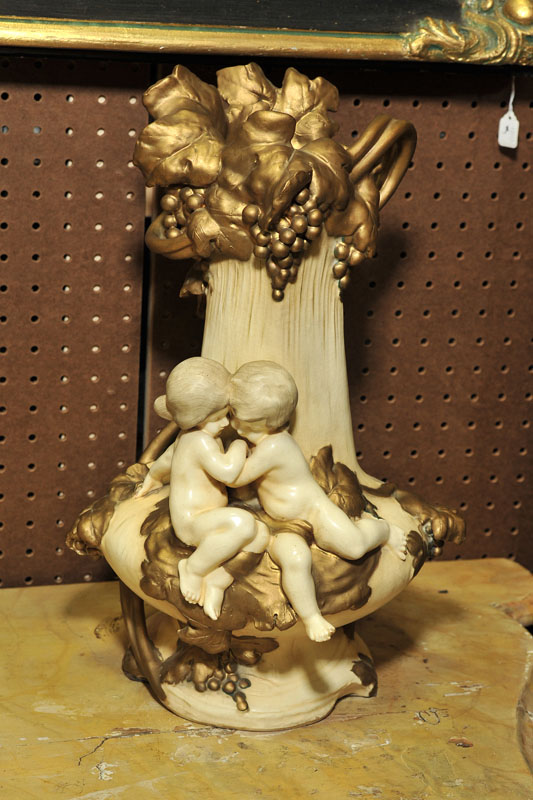 Appraisal: AMPHORA VASE Large cream colored vase with cherubs and gilt