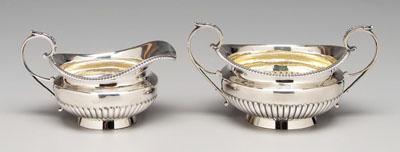 Appraisal: English silver creamer sugar round with half-fluted body scroll borders